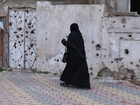 Syrian Umm Mohammed, arrives to a literacy school in the rebel-held town of Douma, on the outskirts of the capital Damascus, on March 25, 20...