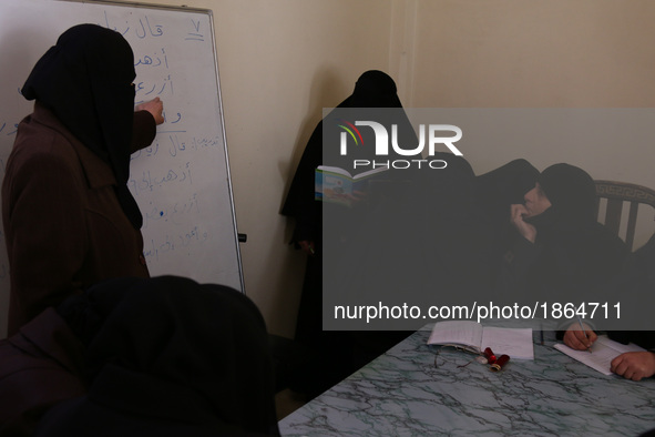 Syrian Umm Mohammed (2-R), attends a literacy class in the rebel-held town of Douma, on the outskirts of the capital Damascus, on March 25,...