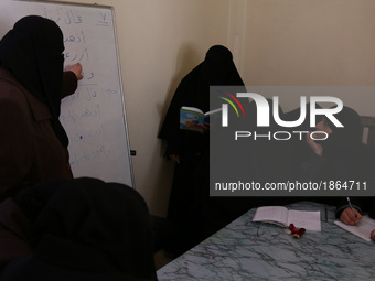 Syrian Umm Mohammed (2-R), attends a literacy class in the rebel-held town of Douma, on the outskirts of the capital Damascus, on March 25,...