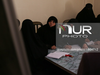 Syrian Umm Mohammed (2-R), attends a literacy class in the rebel-held town of Douma, on the outskirts of the capital Damascus, on March 25,...