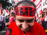 A demonstrator holds up a sign that reads 'Out Temer' during a workers union protest against President Michel Temer's government on Labor Da...