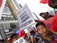 A demonstrator holds up a sign that reads 'Out Temer' during a workers union protest against President Michel Temer's government on Labor Da...