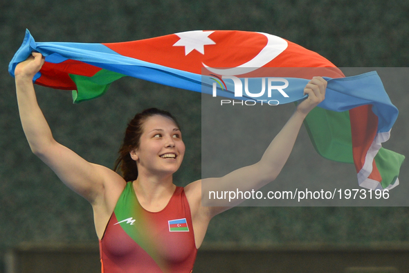 Tetiana Omelchenko of Azerbaijan celebrates after winning against Nur Adakan Gamze of Turkey in the Women's Freestyle 60kg Wrestling final d...