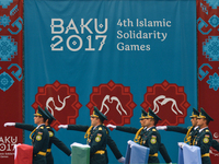 Members of the Azerbaijani Army carry flags ahead of the Women's Freestyle 69kg Wrestling medals ceremony during Baku 2017 - 4th Islamic Sol...