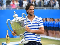 Feliciano Lopez of Spain celebrates with the winners trophy following victory in the mens singles final against Marin Cilic of Croatia durin...