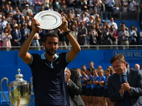 Marin Cilic celebrates with his trophy following 2nd podium in the mens singles final against Feliciano Lopez of Spain during day seven of t...