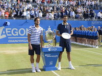 Winner, Feliciano Lopez of Spain (L) and runner up Marin Cilic of Croatia (R) celebrate with the trophies following their mens singles final...