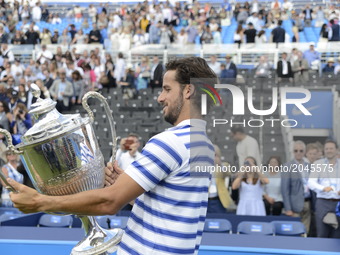 Feliciano Lopez of Spain celebrates with the Trophy, after his victory against Marin Cilic of Croatia in their Men's Singles Final Match dur...