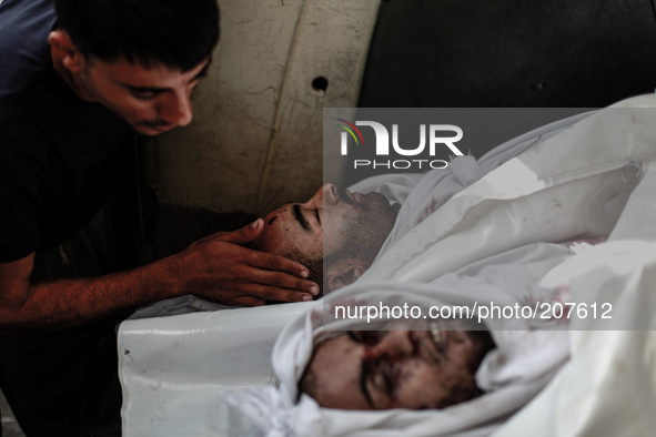 Body of a member of the Abu Nejim family, whom medics said was killed along with other eight family members by an Israeli air strike, during...