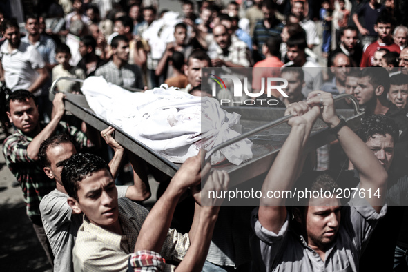 Palestinians carry the body of a member of the Abu Nejim family, whom medics said was killed along with other eight family members by an Isr...