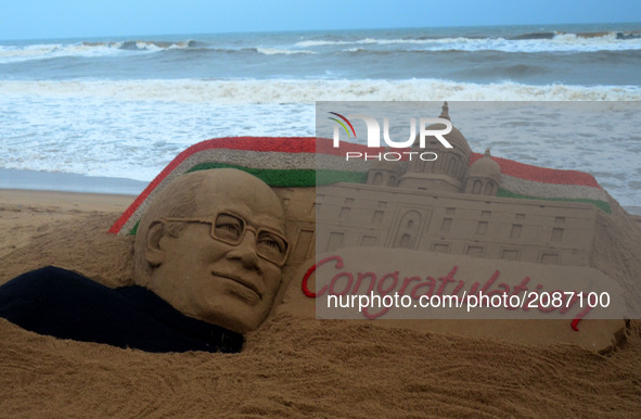 A sand sculpture of newly elected President of India Ramnath Kovind's is seen at the Bay of Bengal Sea's eastern coast beach at Puri as it c...