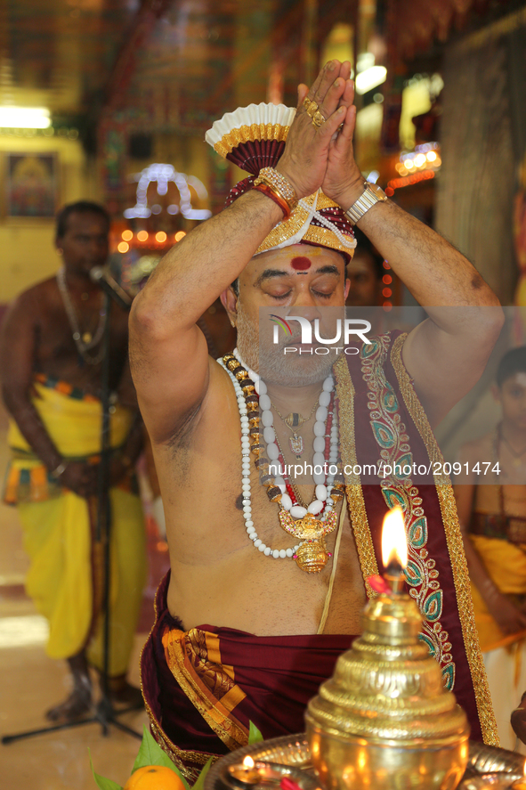 Tamil Hindu priest performs special prayers honouring Lord Ganesh during the Nambiyaandaar Nambi Ustavam Thiruvizha pooja at a Hindu Temple...