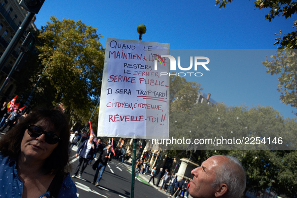 A man looks at his placard reading 'When police will be the last public service, it will be too late, citizens, wake up !'. More than 15000...