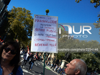 A man looks at his placard reading 'When police will be the last public service, it will be too late, citizens, wake up !'. More than 15000...