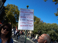 A man looks at his placard reading 'When police will be the last public service, it will be too late, citizens, wake up !'. More than 15000...