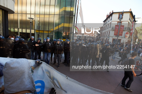 Youths confront riot police at the end of the demonstration. More than 15000 protesters took to the streets of Toulouse against the new Macr...