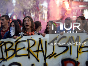 Youths shout slogans against Macron's politics. the banner reads 'liberalism'. More than 15000 protesters took to the streets of Toulouse ag...