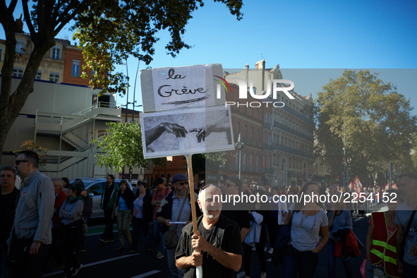 A man holds a placrd reading 'Strike'. More than 15000 protesters took to the streets of Toulouse against the new Macron's reforms on the Wo...