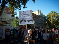 A man holds a placrd reading 'Strike'. More than 15000 protesters took to the streets of Toulouse against the new Macron's reforms on the Wo...