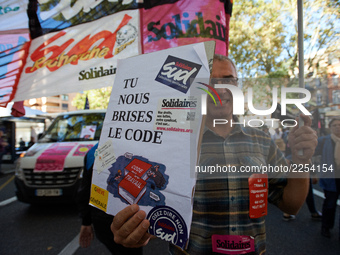 A man shows a placard reading 'You breaks us our Work code'. More than 15000 protesters took to the streets of Toulouse against the new Macr...