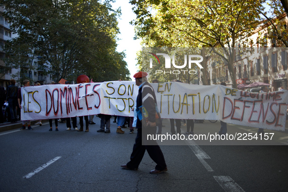 A protester walks in front of a banner reading 'subjugated people are always in legitimate defense situation'.  More than 15000 protesters t...