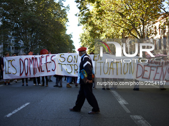 A protester walks in front of a banner reading 'subjugated people are always in legitimate defense situation'.  More than 15000 protesters t...