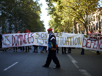 A protester walks in front of a banner reading 'subjugated people are always in legitimate defense situation'.  More than 15000 protesters t...