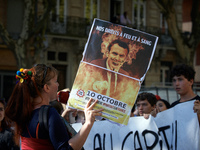 A woman shouts slogans against Macron while holding a placrad depicting French President Macron. More than 15000 protesters took to the stre...