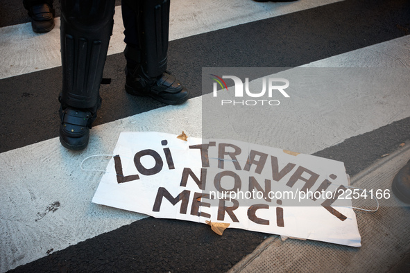 Legs of a riot policeman near a placard reading 'Law on work ? No thanks !'. More than 15000 protesters took to the streets of Toulouse agai...