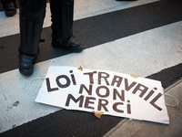 Legs of a riot policeman near a placard reading 'Law on work ? No thanks !'. More than 15000 protesters took to the streets of Toulouse agai...