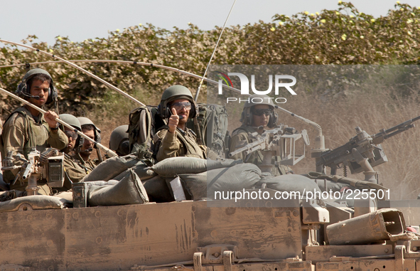 An Israeli tank crew drives back inside the Gaza Strip to continue with Israel’s Operation Margin Protector. 