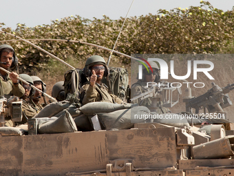 An Israeli tank crew drives back inside the Gaza Strip to continue with Israel’s Operation Margin Protector. (