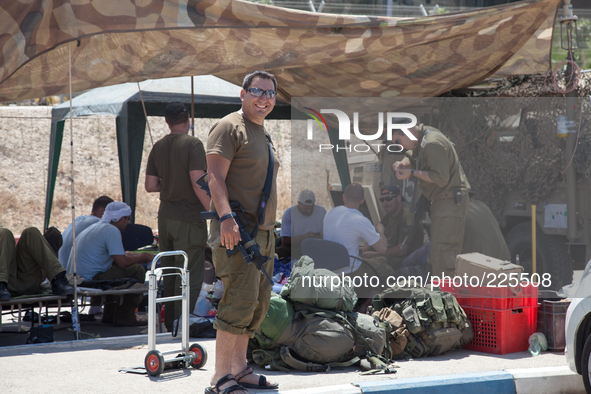 An Israeli soldier and his unit at the outpost located in Erez border crossing, hours after they made it back from fighting Hamas militants...