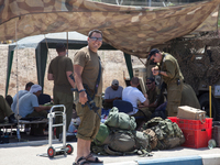 An Israeli soldier and his unit at the outpost located in Erez border crossing, hours after they made it back from fighting Hamas militants...