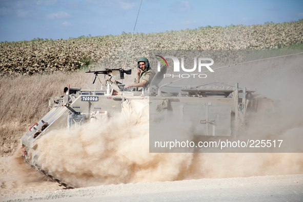 An Israeli armored troop transport vehicle on its way into the Gaza strip during Operation Margin Protector. 