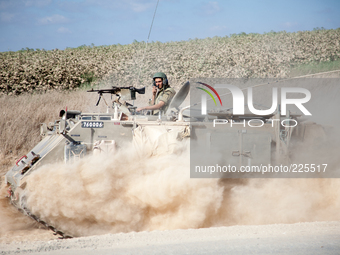 An Israeli armored troop transport vehicle on its way into the Gaza strip during Operation Margin Protector. (