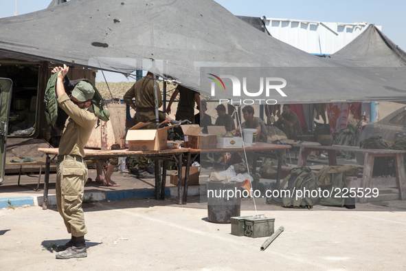 An Israeli soldier putting on the bullet proof vest at military outpost in the border crossing of Erez. 