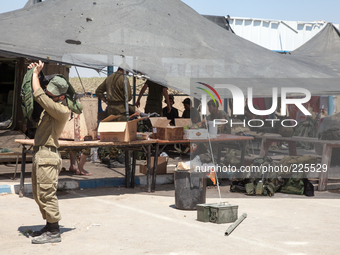 An Israeli soldier putting on the bullet proof vest at military outpost in the border crossing of Erez. (