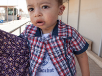 A Palestinian boy waiting to cross back into the Gaza Strip despite the ongoing fighting. (