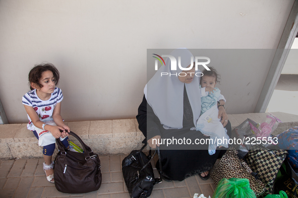 A Palestinian family waits their turn to be inspected by Israeli authorities before crossing the border in Erez and back into Gaza. 