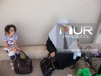 A Palestinian family waits their turn to be inspected by Israeli authorities before crossing the border in Erez and back into Gaza. (