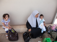 A Palestinian family waits their turn to be inspected by Israeli authorities before crossing the border in Erez and back into Gaza. (