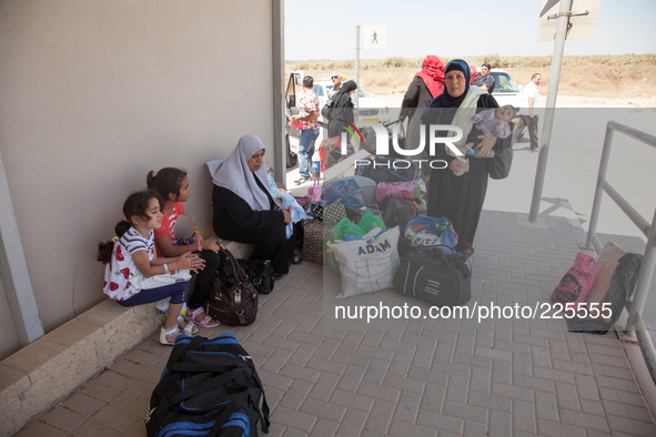 Palestinian children with their mothers waiting to cross the border Erez to go back inside Gaza despite the fighting there. 