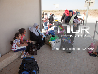 Palestinian children with their mothers waiting to cross the border Erez to go back inside Gaza despite the fighting there. (