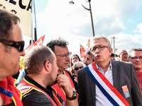 Secretary general of the French Communist Party, Pierre Laurent (C) takes part in a Metalworkers demonstration as they march with banners an...