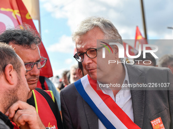 Secretary general of the French Communist Party, Pierre Laurent (C) takes part in a Metalworkers demonstration as they march with banners an...