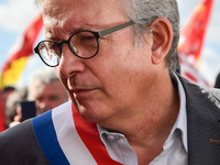 Secretary general of the French Communist Party, Pierre Laurent (C) takes part in a Metalworkers demonstration as they march with banners an...