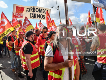 Metalworkers demonstrate as they march with banners and flags in the streets of Paris on October 13, 2017. Several thousand workers have tak...