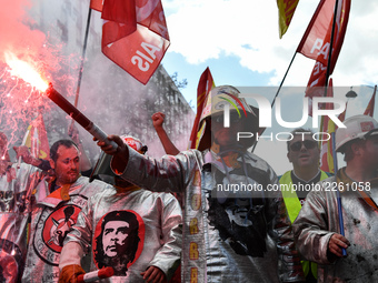 Metalworkers demonstrate as they march with banners and flags in the streets of Paris on October 13, 2017. Several thousand workers have tak...