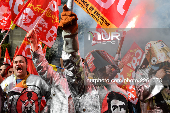 Metalworkers demonstrate as they march with banners and flags in the streets of Paris on October 13, 2017. Several thousand workers have tak...